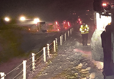 Photo of a tanker truck rolled in median.